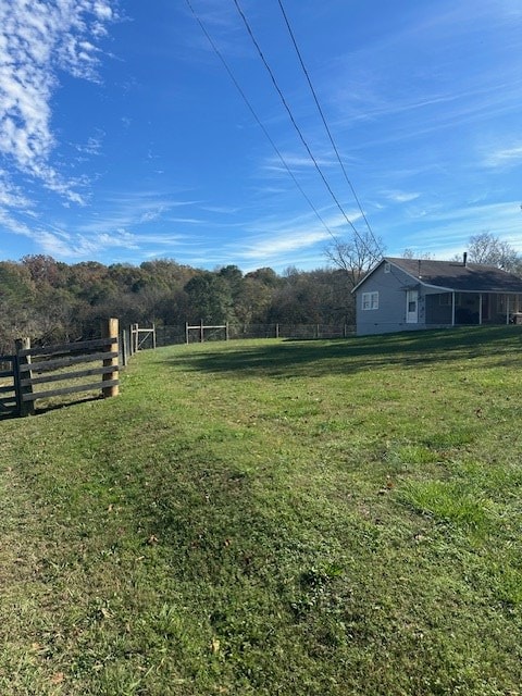 view of yard with a rural view