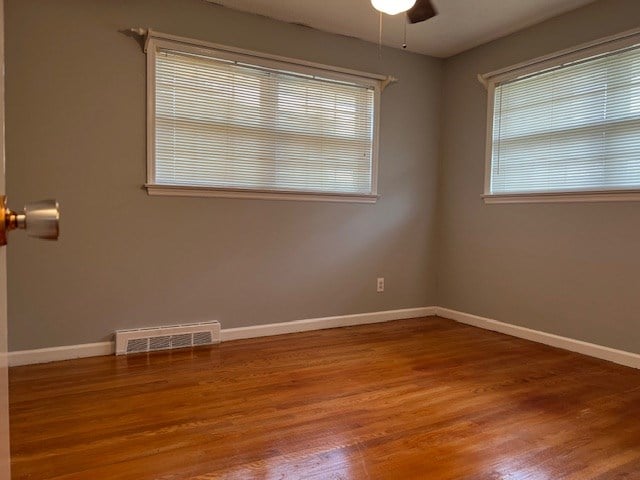 empty room featuring ceiling fan and hardwood / wood-style floors