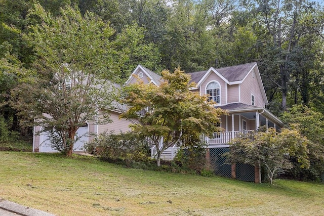 view of side of property featuring a porch and a lawn