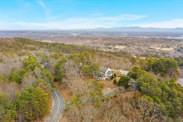 drone / aerial view with a mountain view and a view of trees