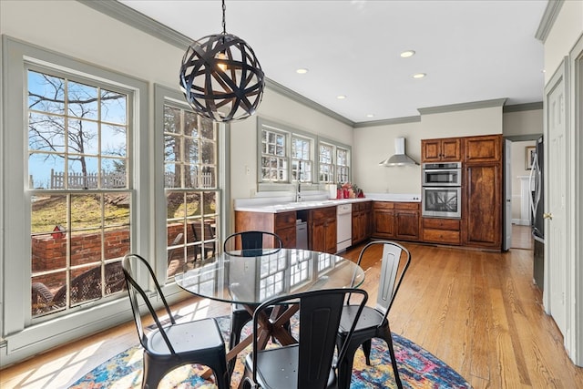 dining area with recessed lighting, light wood finished floors, and ornamental molding