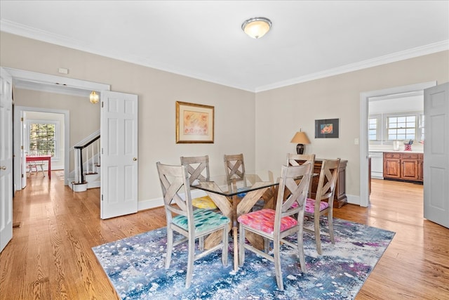 dining area with stairway, baseboards, light wood-style floors, and crown molding