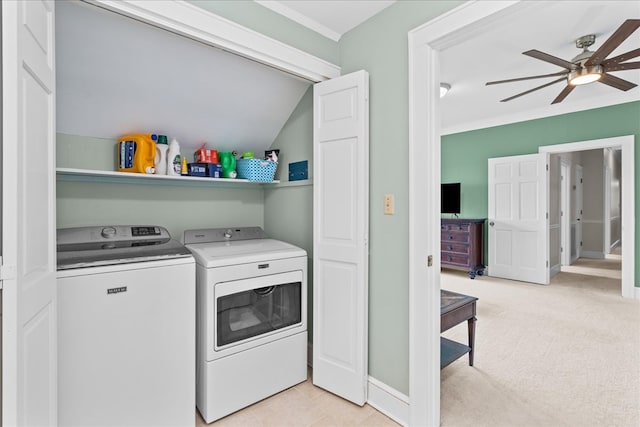 laundry room with light carpet, ornamental molding, a ceiling fan, washer and clothes dryer, and laundry area