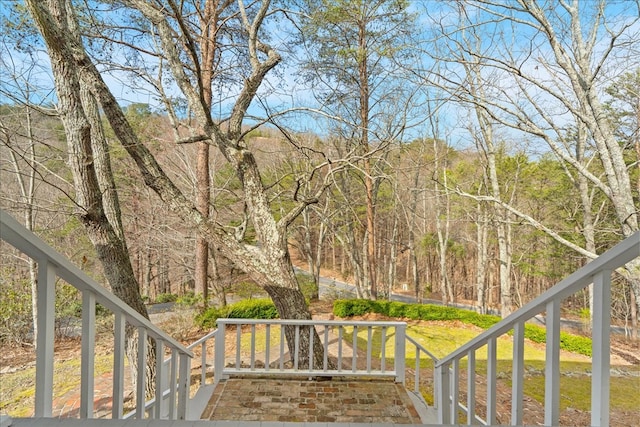 wooden deck with a view of trees