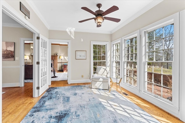 unfurnished room featuring wood finished floors, visible vents, baseboards, ornamental molding, and french doors