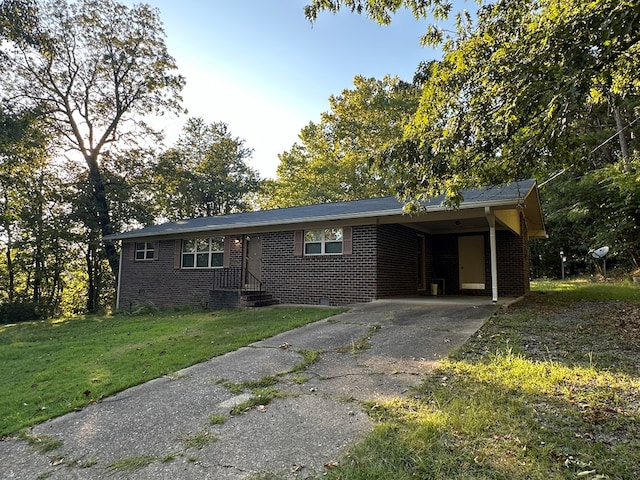 ranch-style house featuring a carport and a front lawn