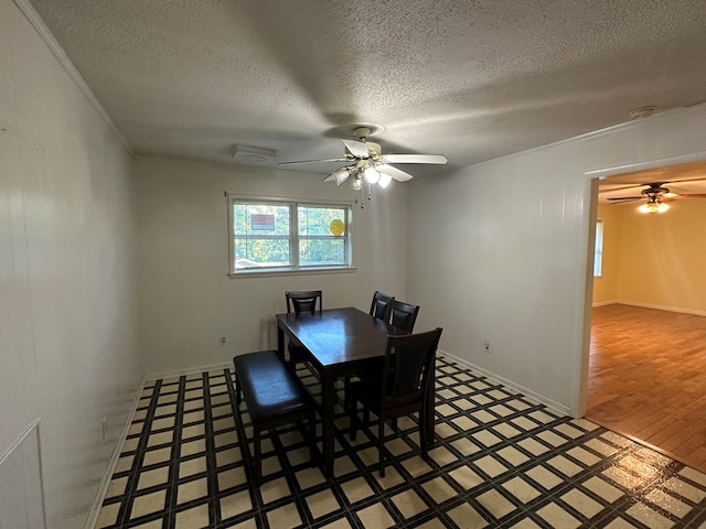 dining space with ceiling fan and a textured ceiling