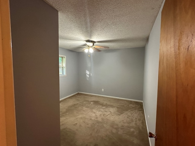 carpeted empty room with a textured ceiling and ceiling fan