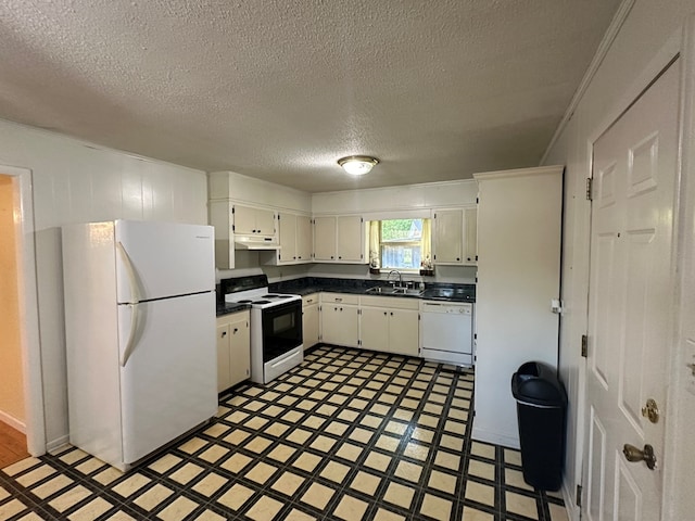 kitchen featuring sink, a textured ceiling, and white appliances