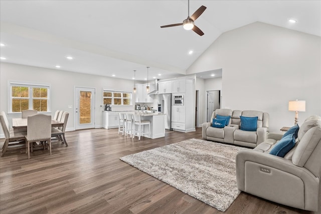 living room with ceiling fan, dark hardwood / wood-style floors, and high vaulted ceiling