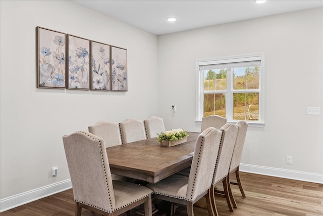 dining space with hardwood / wood-style flooring