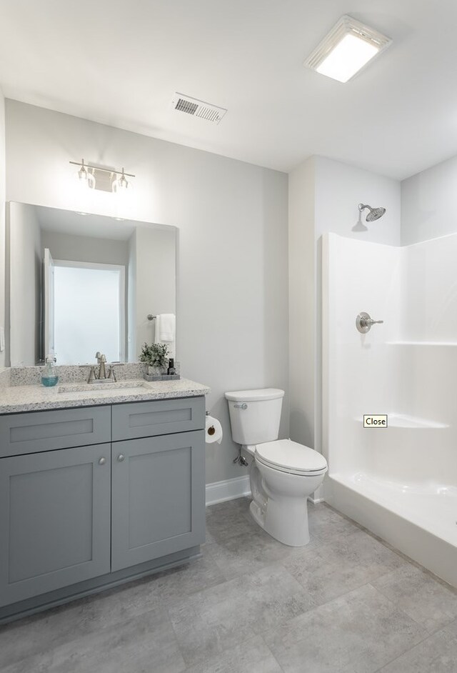 141 Andros Dr, Dalton, GA 30721 - bathroom featuring vanity, toilet, baseboards, and bathtub / shower combination