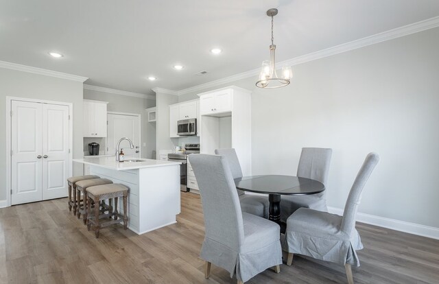 141 Andros Dr, Dalton, GA 30721 - dining space with light wood-style flooring, crown molding, recessed lighting, and baseboards