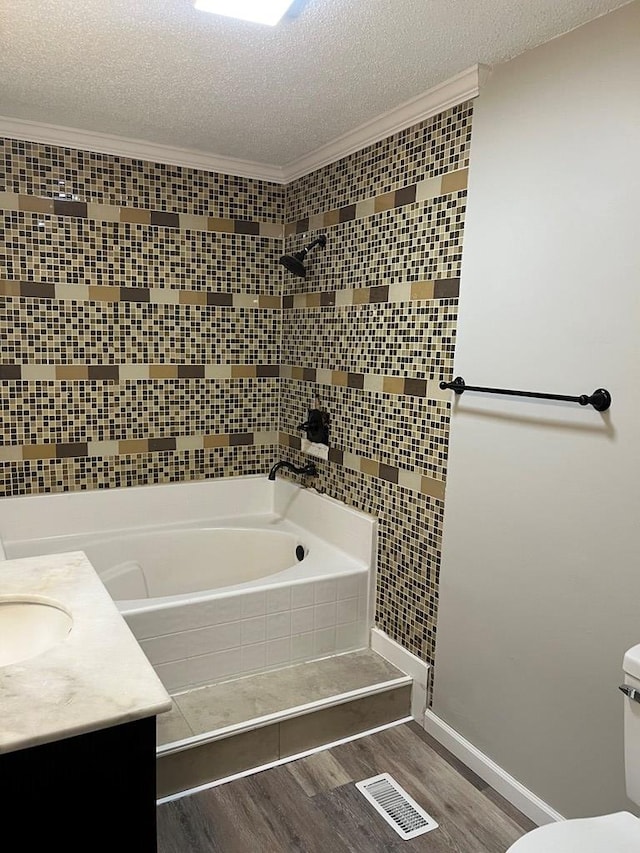 830 Chattanooga Rd, Cohutta, GA 30710 - full bathroom featuring wood finished floors, a textured ceiling, crown molding, vanity, and tiled shower / bath