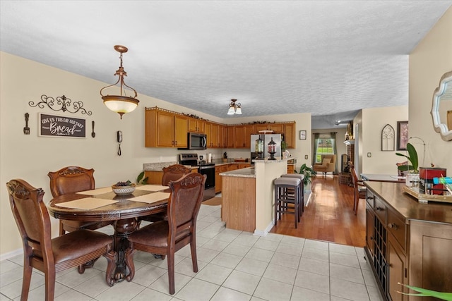 217 Valley Rd, Chatsworth, GA 30705 - dining space featuring a textured ceiling and light tile patterned flooring