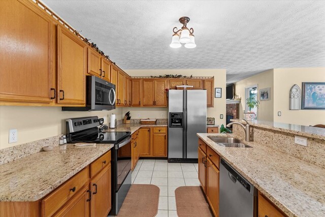 217 Valley Rd, Chatsworth, GA 30705 - kitchen featuring appliances with stainless steel finishes, brown cabinets, light tile patterned flooring, a chandelier, and a textured ceiling