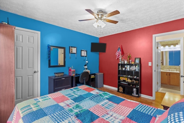 217 Valley Rd, Chatsworth, GA 30705 - bedroom featuring a textured ceiling, wood finished floors, ceiling fan, and ensuite bath