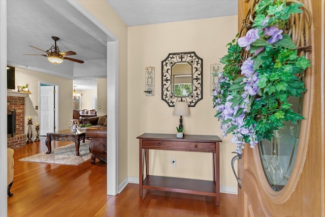 217 Valley Rd, Chatsworth, GA 30705 - entryway featuring wood finished floors, a ceiling fan, and a fireplace