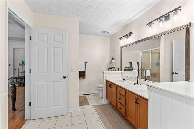 217 Valley Rd, Chatsworth, GA 30705 - bathroom with double vanity, a shower with shower door, tile patterned flooring, and a textured ceiling