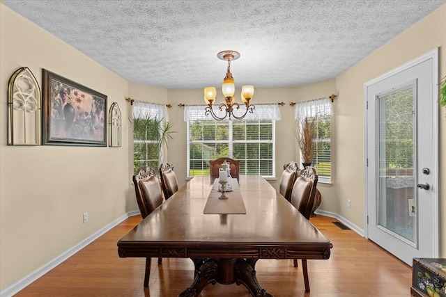 217 Valley Rd, Chatsworth, GA 30705 - dining room featuring a chandelier, light wood-style floors, and a textured ceiling