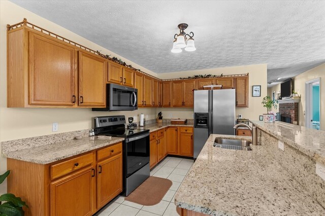 217 Valley Rd, Chatsworth, GA 30705 - kitchen with stainless steel appliances, a textured ceiling, light tile patterned floors, a chandelier, and brown cabinets