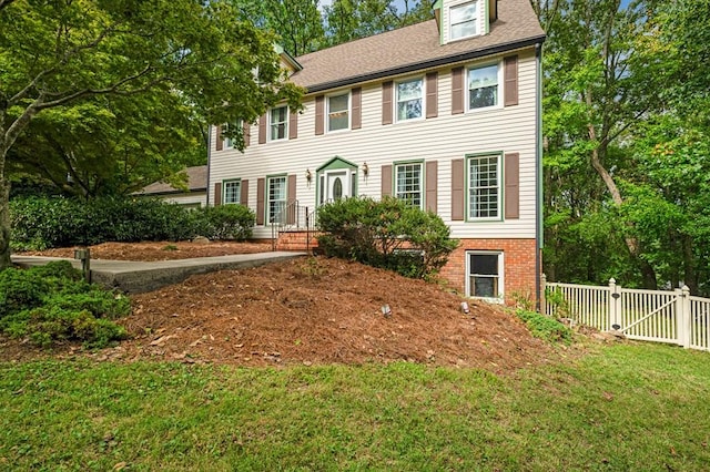 colonial home with a front lawn