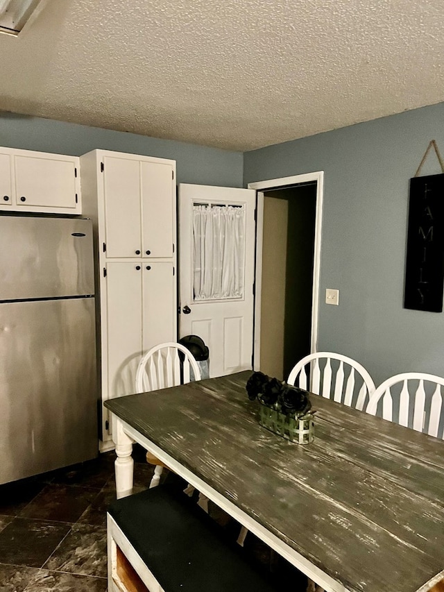 4781 Treetop Ln, Cohutta, GA 30710 - dining space with a textured ceiling and stone finish flooring