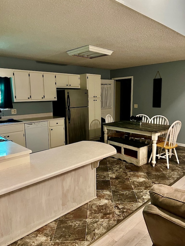 4781 Treetop Ln, Cohutta, GA 30710 - kitchen featuring freestanding refrigerator, a textured ceiling, white cabinetry, and white dishwasher