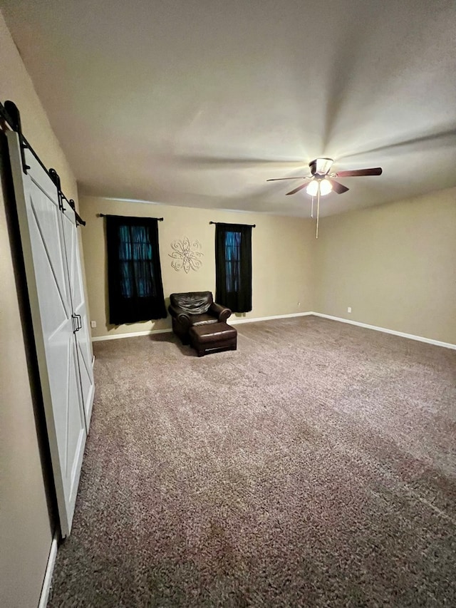 4781 Treetop Ln, Cohutta, GA 30710 - unfurnished room with a ceiling fan, a barn door, baseboards, and carpet floors