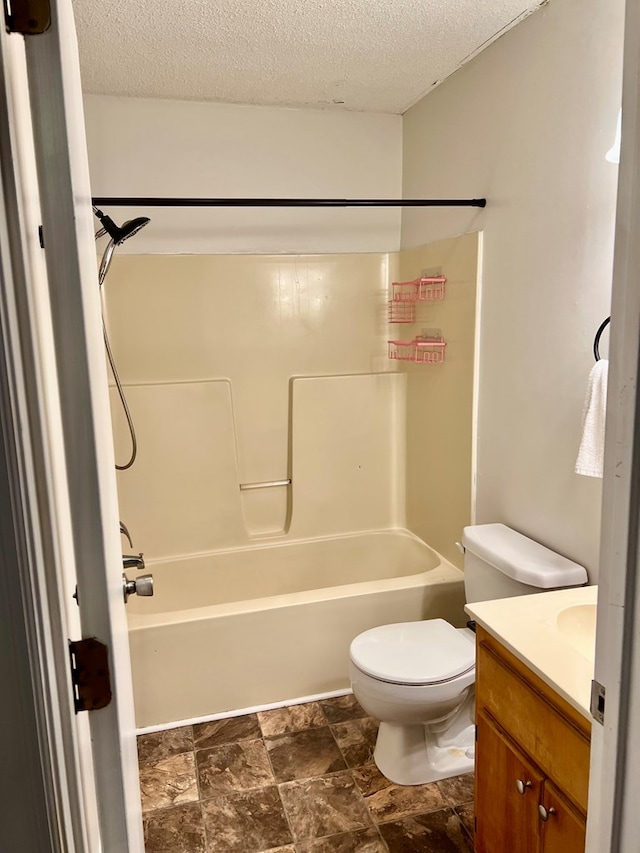 4781 Treetop Ln, Cohutta, GA 30710 - bathroom featuring a textured ceiling, toilet, stone finish flooring, vanity, and tub / shower combination