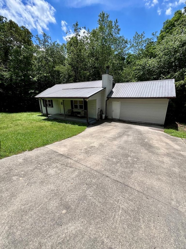 4781 Treetop Ln, Cohutta, GA 30710 - ranch-style home with a chimney, metal roof, covered porch, concrete driveway, and a front lawn