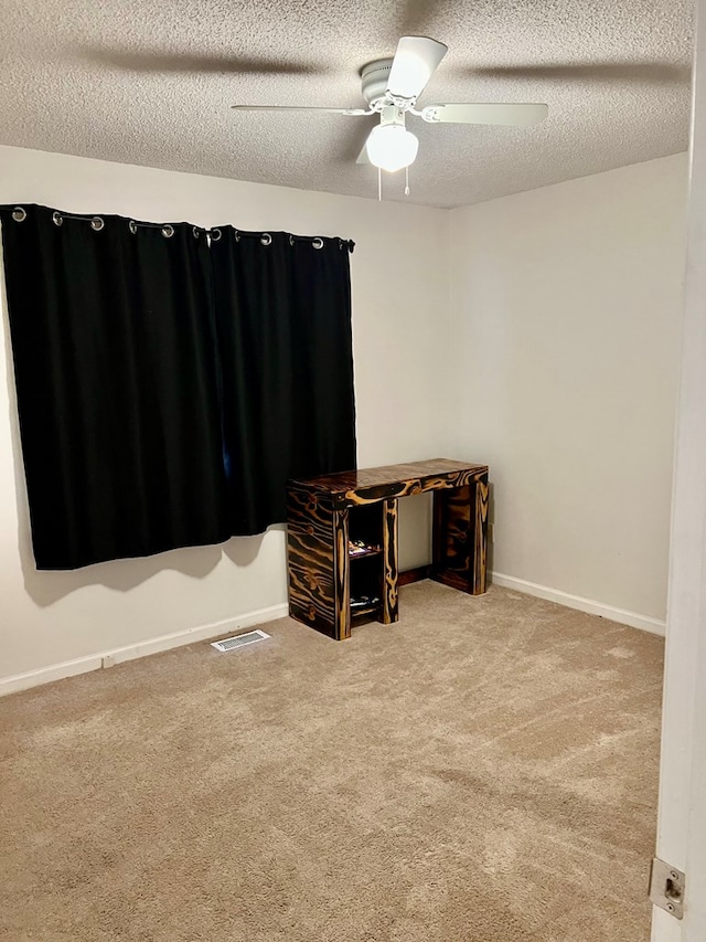 4781 Treetop Ln, Cohutta, GA 30710 - carpeted spare room featuring baseboards, visible vents, ceiling fan, and a textured ceiling
