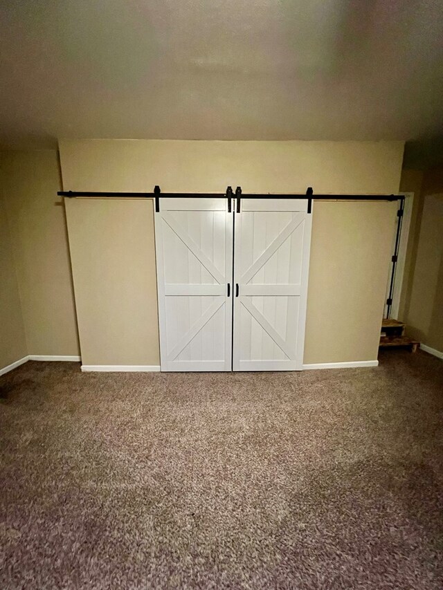 4781 Treetop Ln, Cohutta, GA 30710 - interior space featuring a barn door, baseboards, and carpet floors
