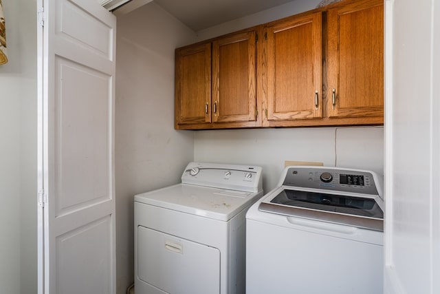 washroom featuring cabinets and separate washer and dryer