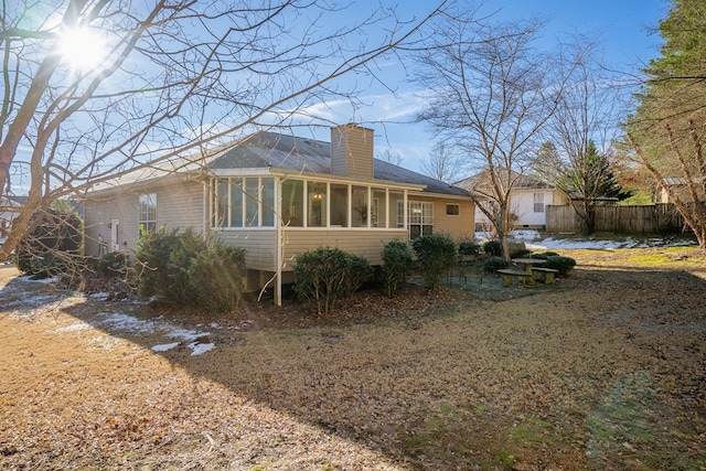 rear view of property with a sunroom