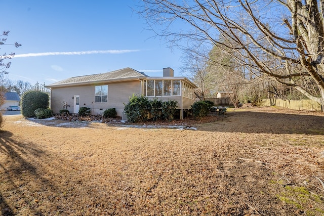 view of side of home featuring a sunroom