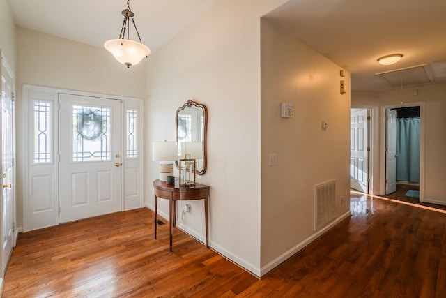 entrance foyer with lofted ceiling and hardwood / wood-style floors