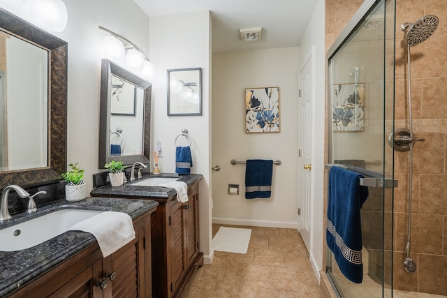 bathroom with vanity and a shower with shower door