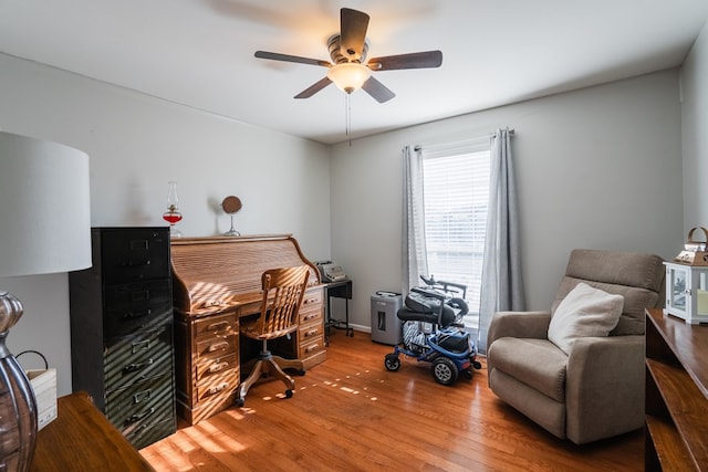 home office with wood-type flooring and ceiling fan