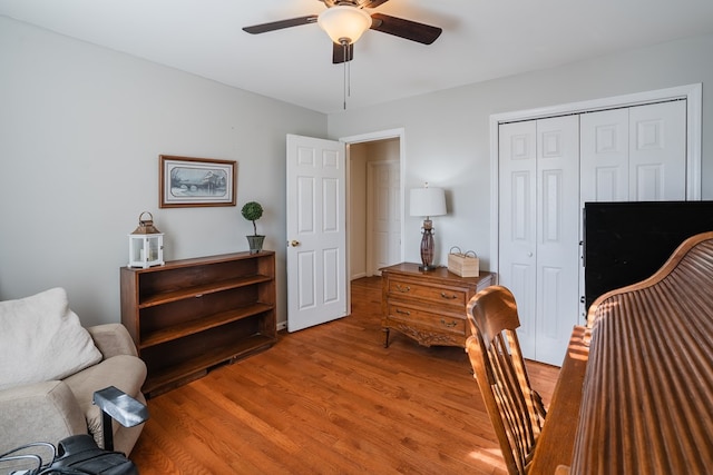 sitting room with hardwood / wood-style floors and ceiling fan