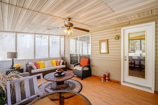 sunroom / solarium with wooden ceiling and ceiling fan