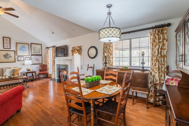 dining room featuring lofted ceiling, light hardwood / wood-style flooring, and ceiling fan