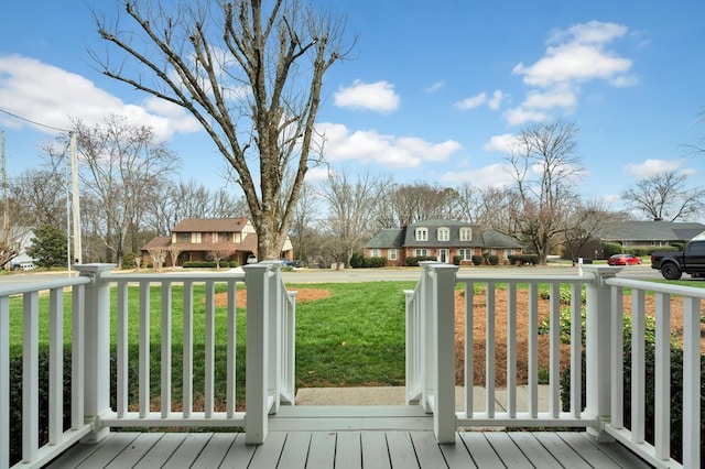 wooden deck featuring a porch and a yard