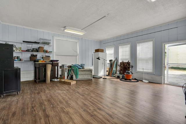 miscellaneous room featuring wood finished floors and a textured ceiling