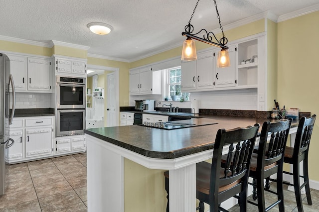 kitchen with a peninsula, open shelves, stainless steel appliances, white cabinetry, and dark countertops