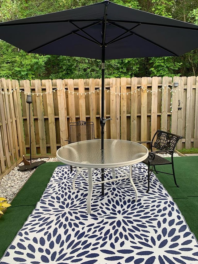 view of patio / terrace with outdoor dining space and fence