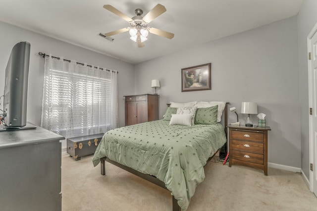 bedroom featuring a ceiling fan, baseboards, visible vents, and light carpet