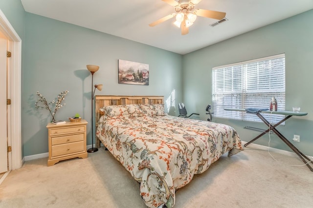 bedroom featuring visible vents, baseboards, and light colored carpet