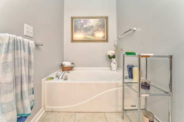 bathroom with tile patterned flooring and a garden tub