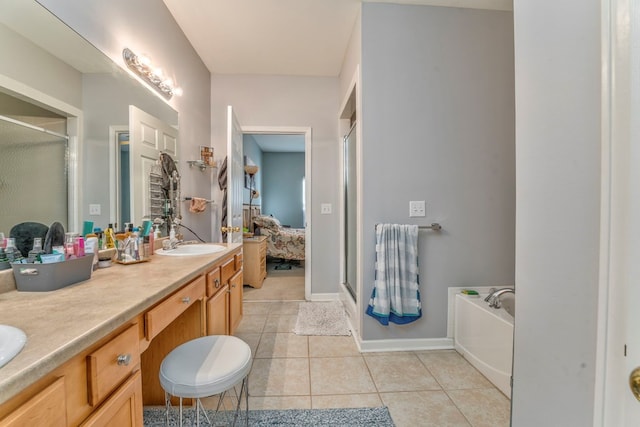 full bath featuring tile patterned floors, connected bathroom, a shower stall, and a sink